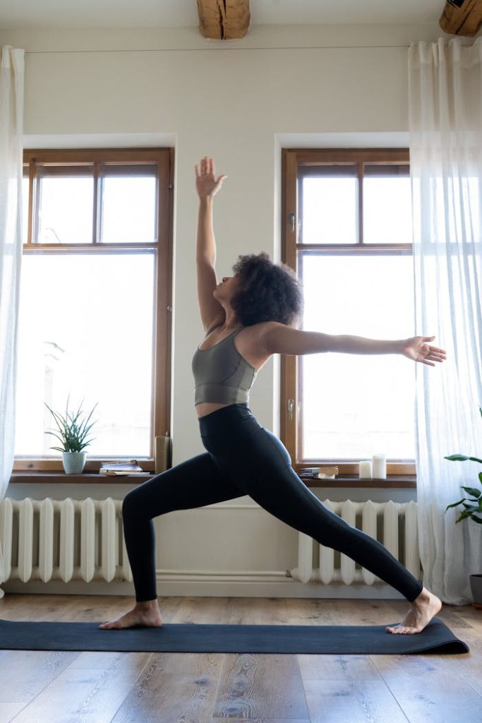 pexels photo 4056531 Woman practicing yoga in a well-lit modern home setting, promoting wellness and tranquility.