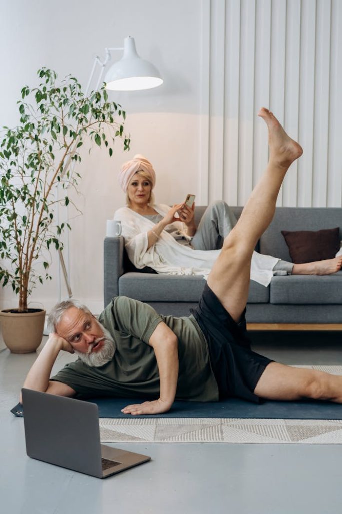 pexels photo 7530002 Elderly couple balancing fitness and relaxation at home, with yoga and online exploration.